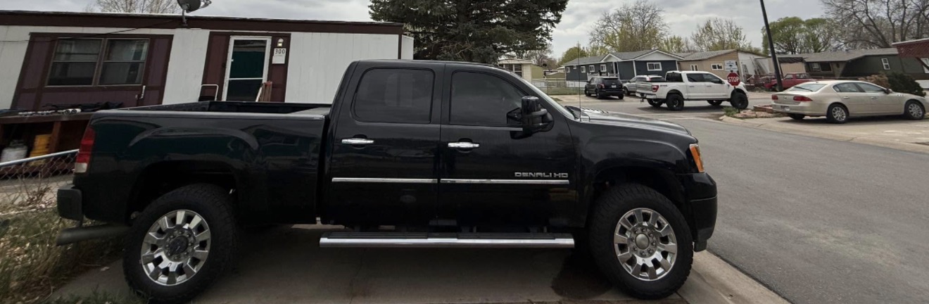 Black GMC Denali HD with premium window tint installed by Tinty in Arvada, Colorado